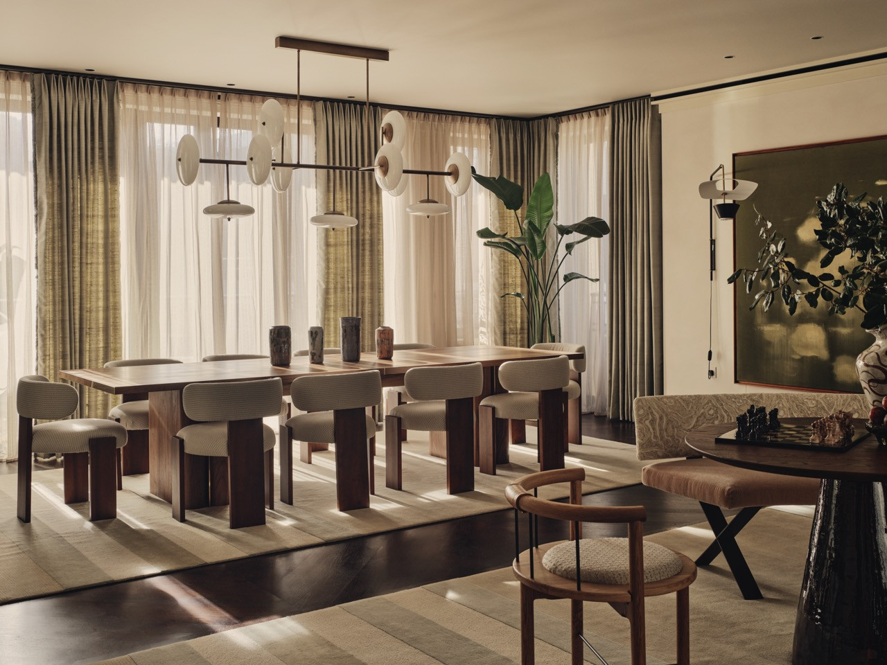 The dining area has a round table and bench seating, demonstrating Bense’s approach to creating multiple functional zones within the open-plan layout