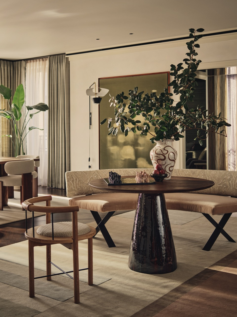 The dining area has a round table and bench seating
