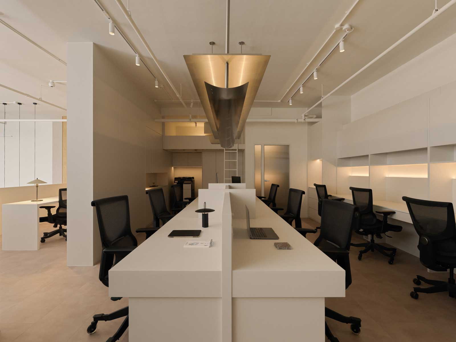 The office space is a sleek, functional zone underpinned by a calming neutral palette and soothing soft illumination for less stressful workdays
