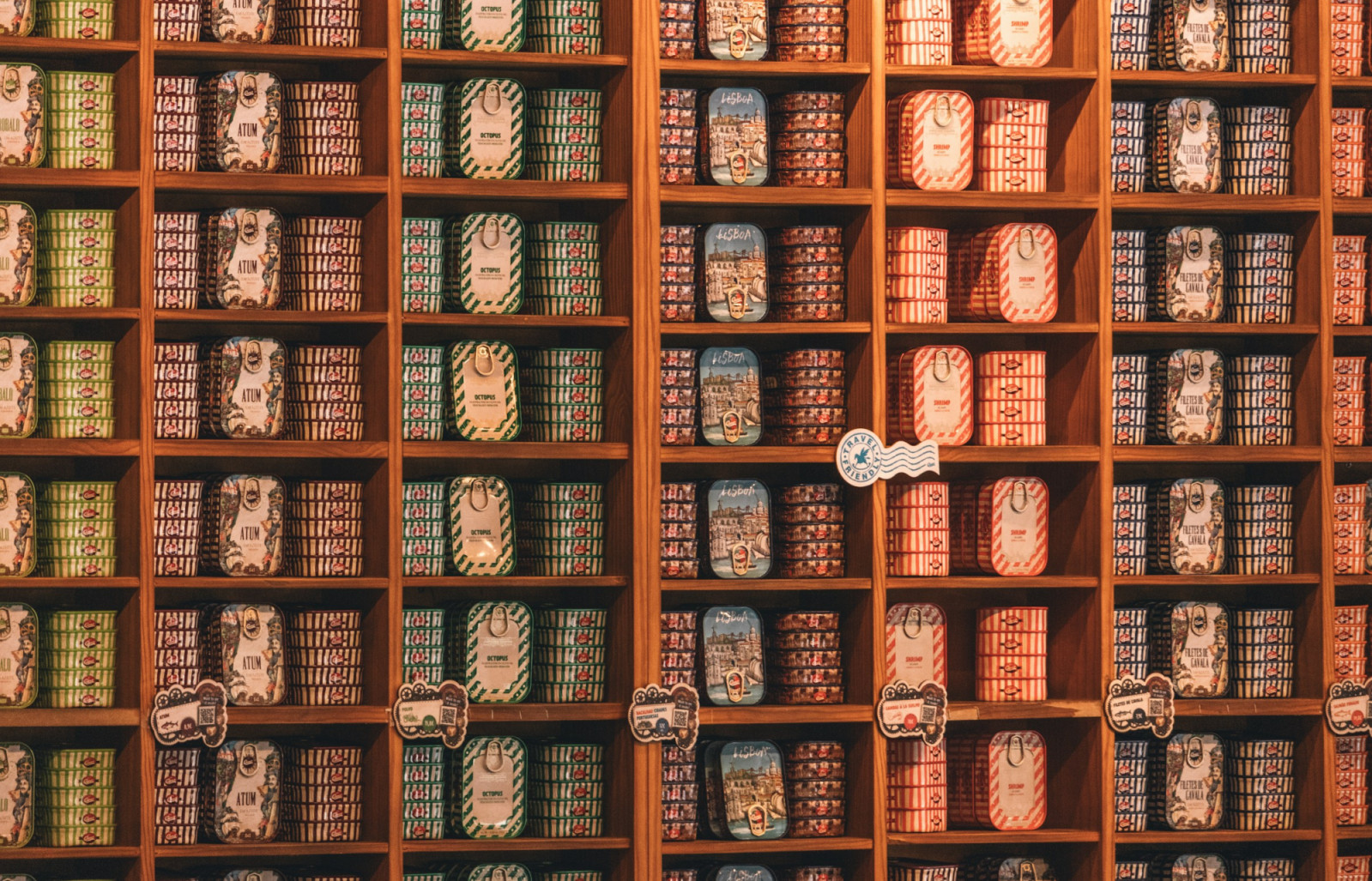 Rows of colourful tins line the shelves of a Lisbon shop, where sardines are celebrated as both pantry staple and local treasure (Photo: Kristijan Arsov/Unsplash)