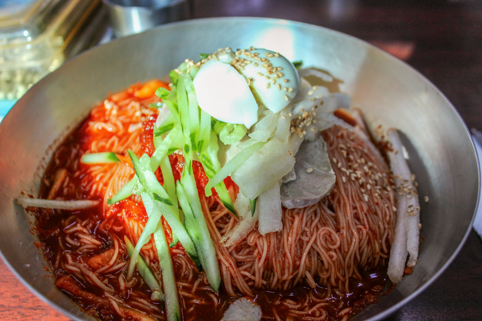 Naengmyeon offers icy broth and chewy noodles topped with crisp cucumber and pear, a refreshing Korean summer staple (Photo: Crystal Jo/Unsplash)