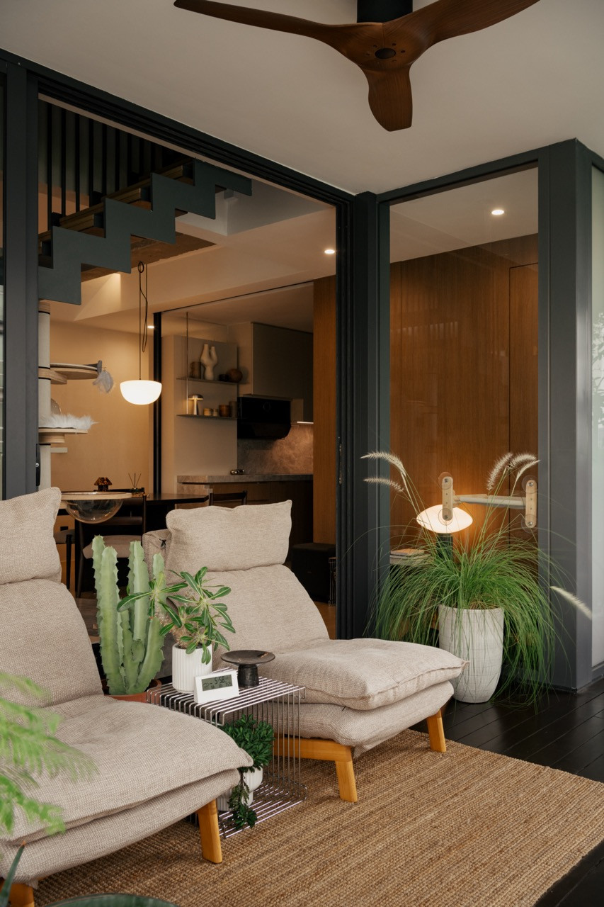 The deck area by the pond with planted greenery and views into the living space, demonstrating the indoor-outdoor connection