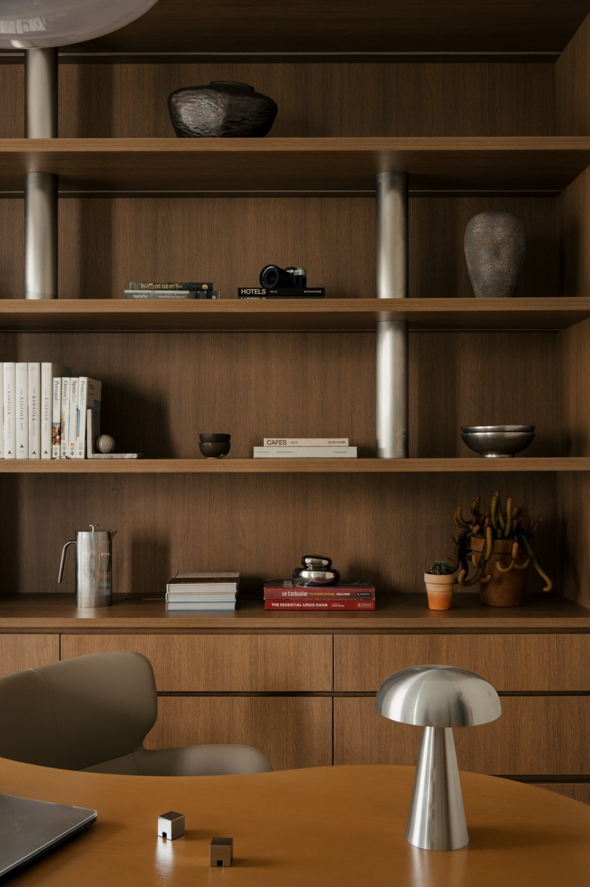 Detail of mezzanine shelving showing stainless steel rods functioning as invisible supports