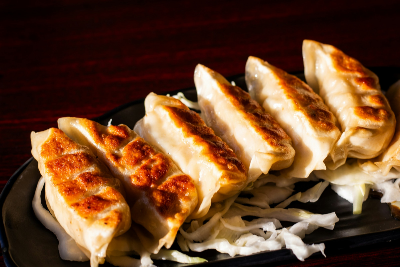 Gyoza are pan-fried until crisp underneath, steamed on top, and made for dipping (Photo: Mikey Frost/Unsplash)