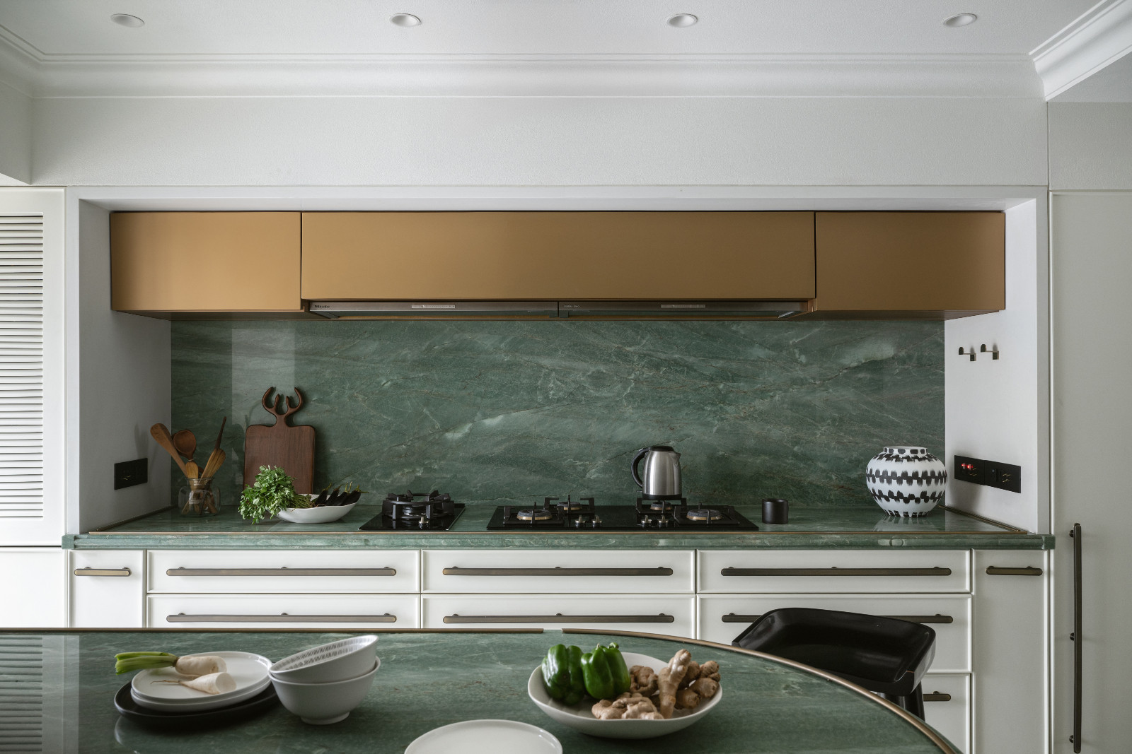 The kitchen in a neoclassical family home designed by Palindrome Space in Mumbai, India