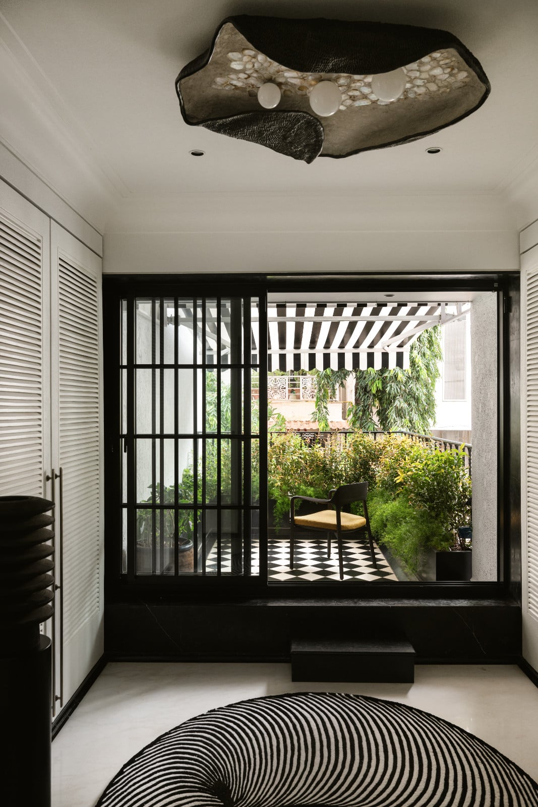 A glimpse of the outdoor terrace in a neoclassical family home designed by Palindrome Space in Mumbai, India