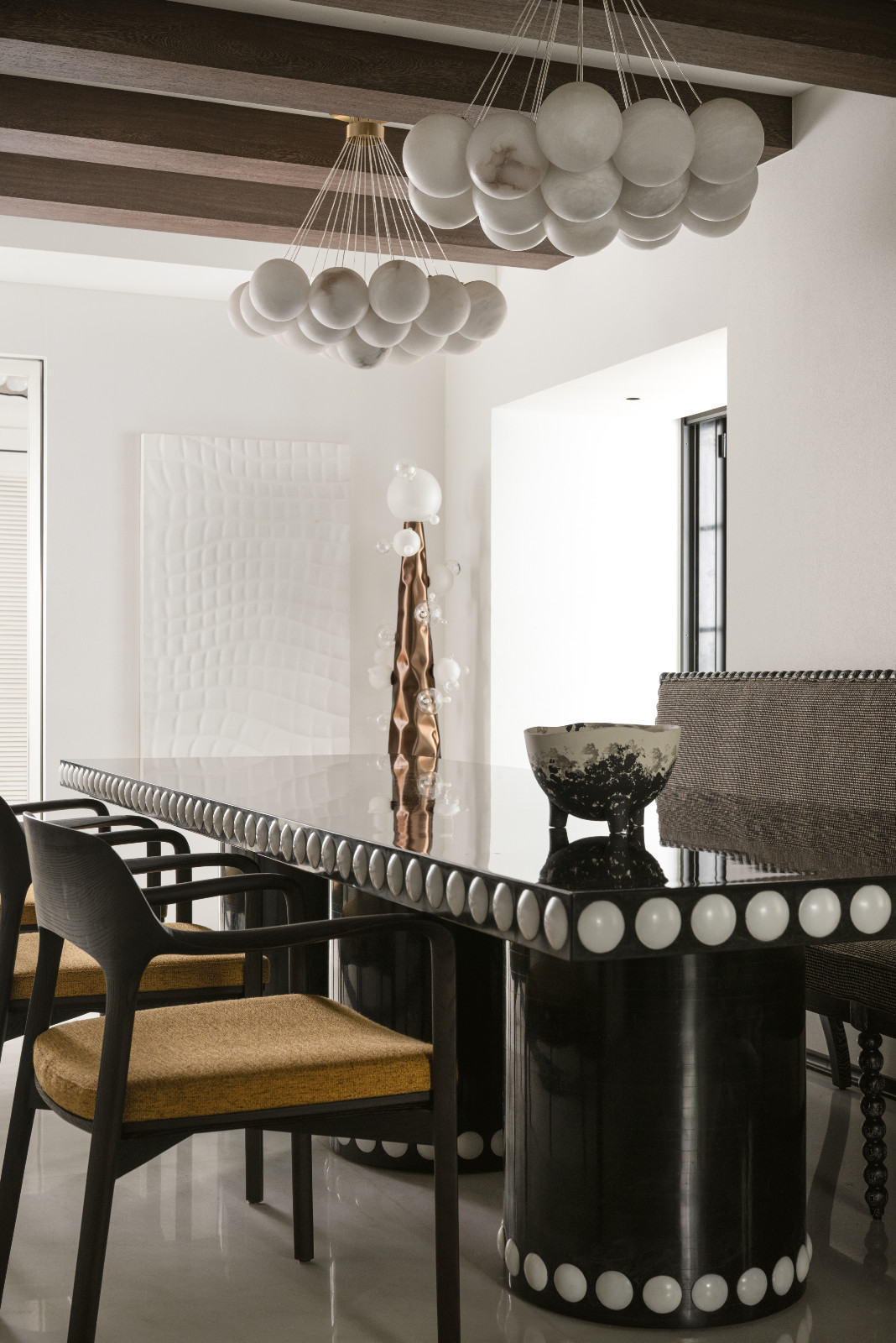 The dining room in a neoclassical family home designed by Palindrome Space in Mumbai, India