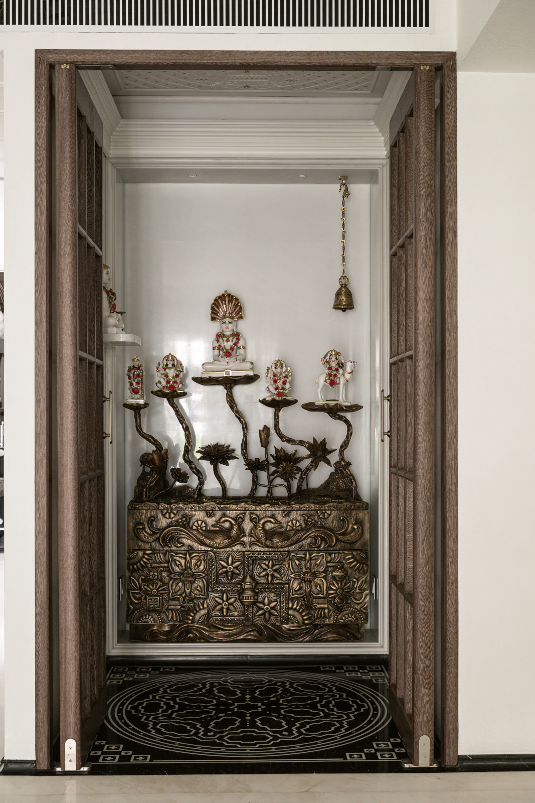 The pooja in a neoclassical family home designed by Palindrome Space in Mumbai, India