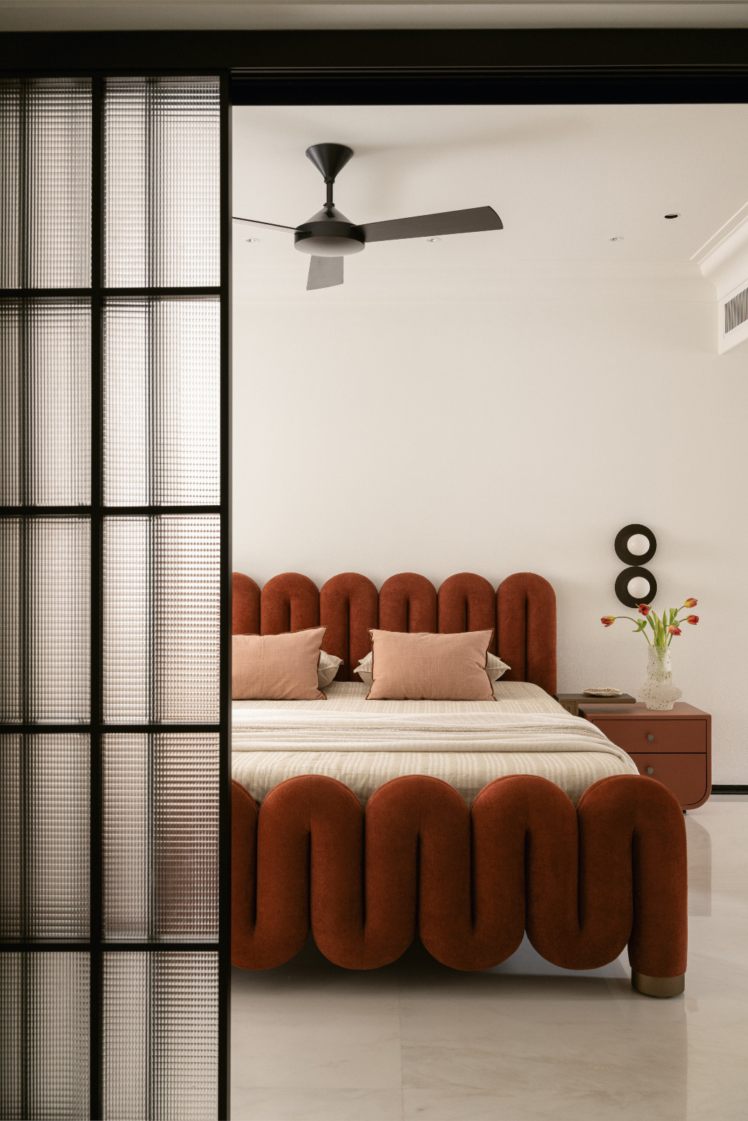 A bedroom in a neoclassical family home designed by Palindrome Space in Mumbai, India