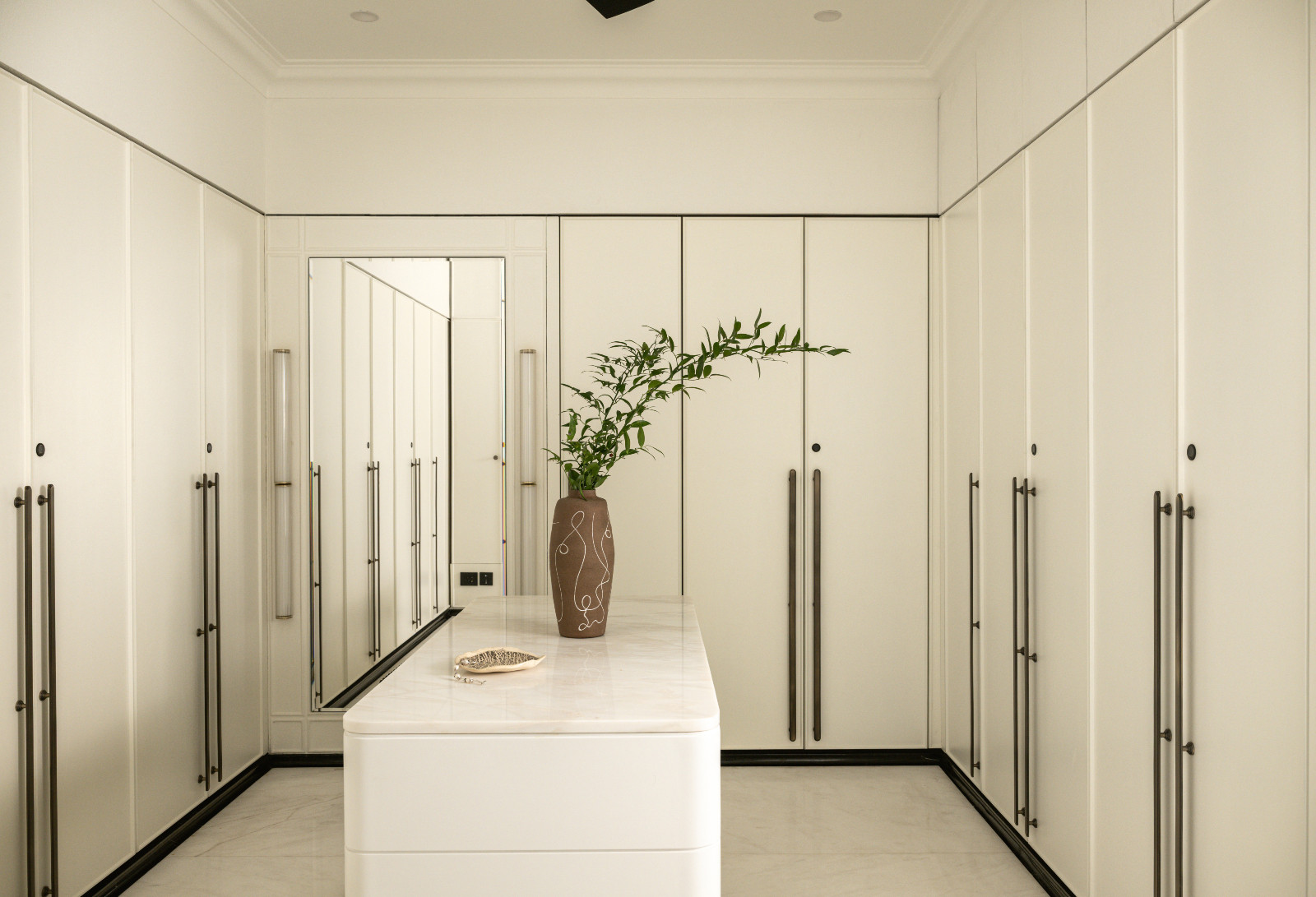 The walk-in closet attached to the primary bedroom in a neoclassical family home designed by Palindrome Space in Mumbai, India