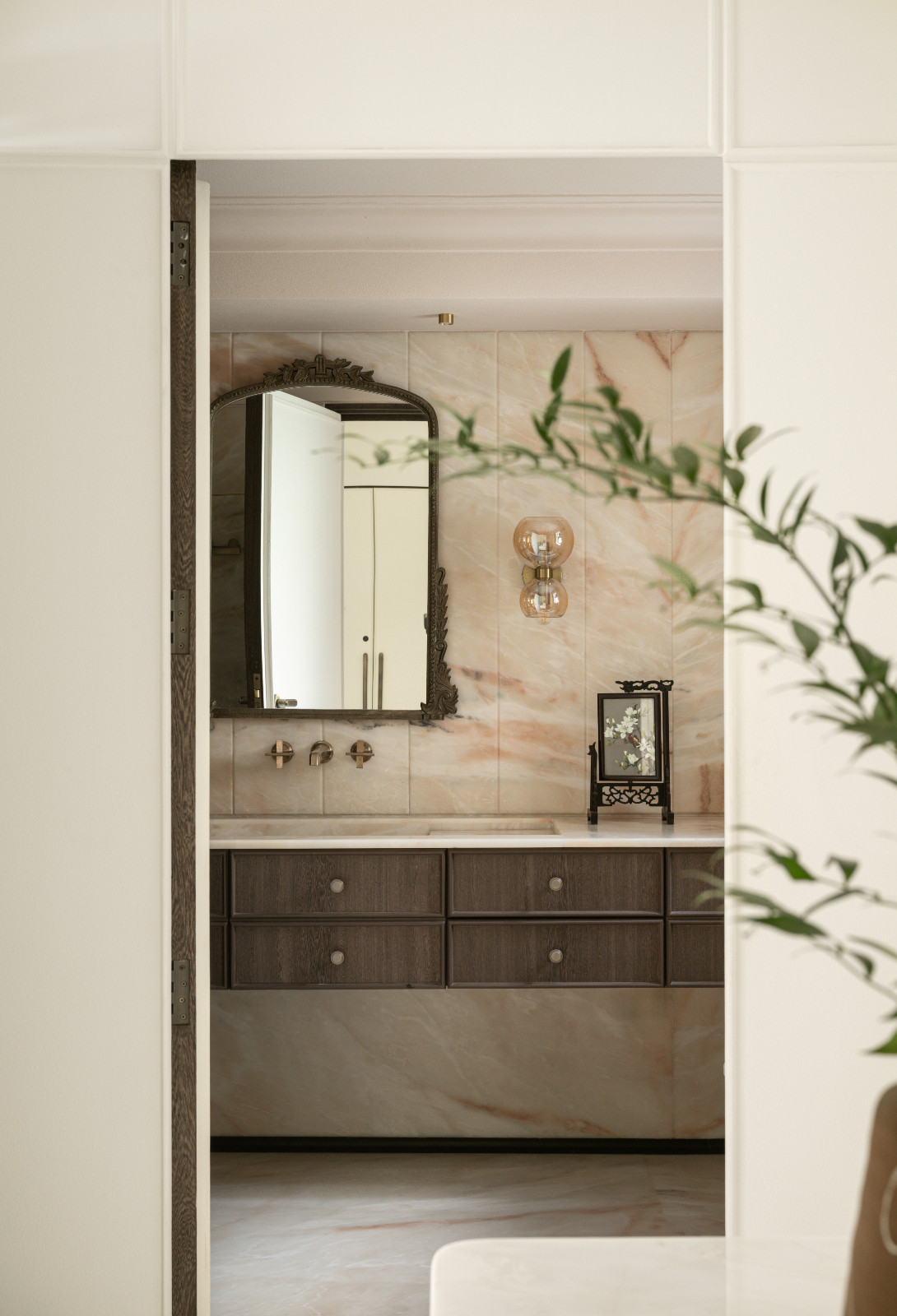 The bathroom attached to the primary bedroom in a neoclassical family home designed by Palindrome Space in Mumbai, India