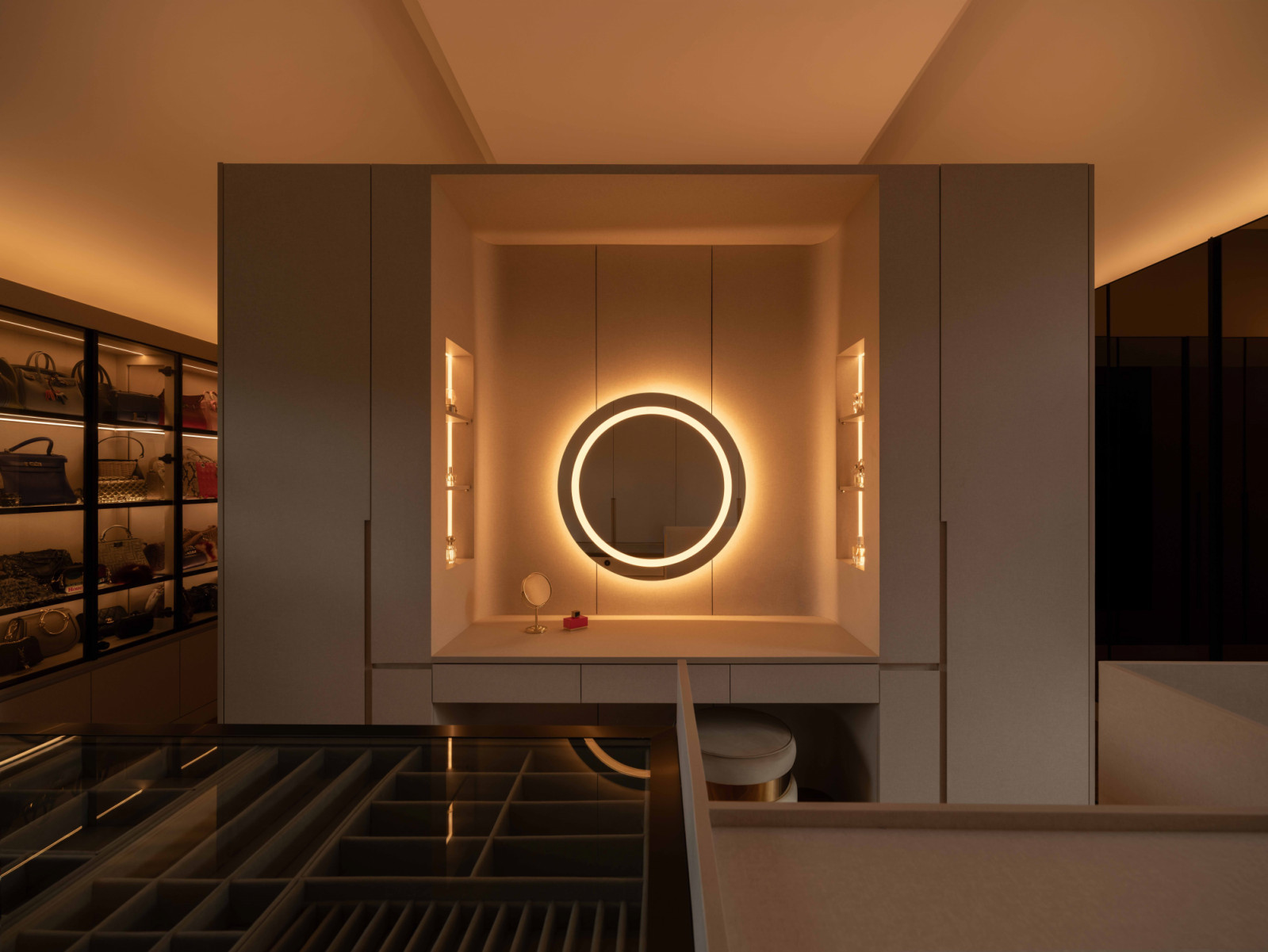 A backlit circular mirror adds visual drama to the Bukit Timah bungalow’s attic dressing area