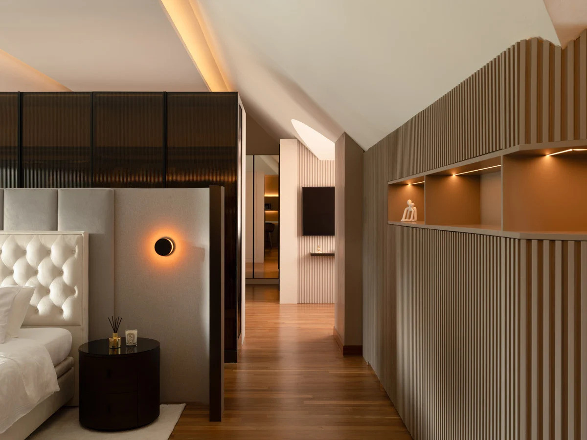 A linear view of the attic suite from the bedroom shows how Designworx skilfully utilised the Bukit Timah bungalow’s challenging roof geometry