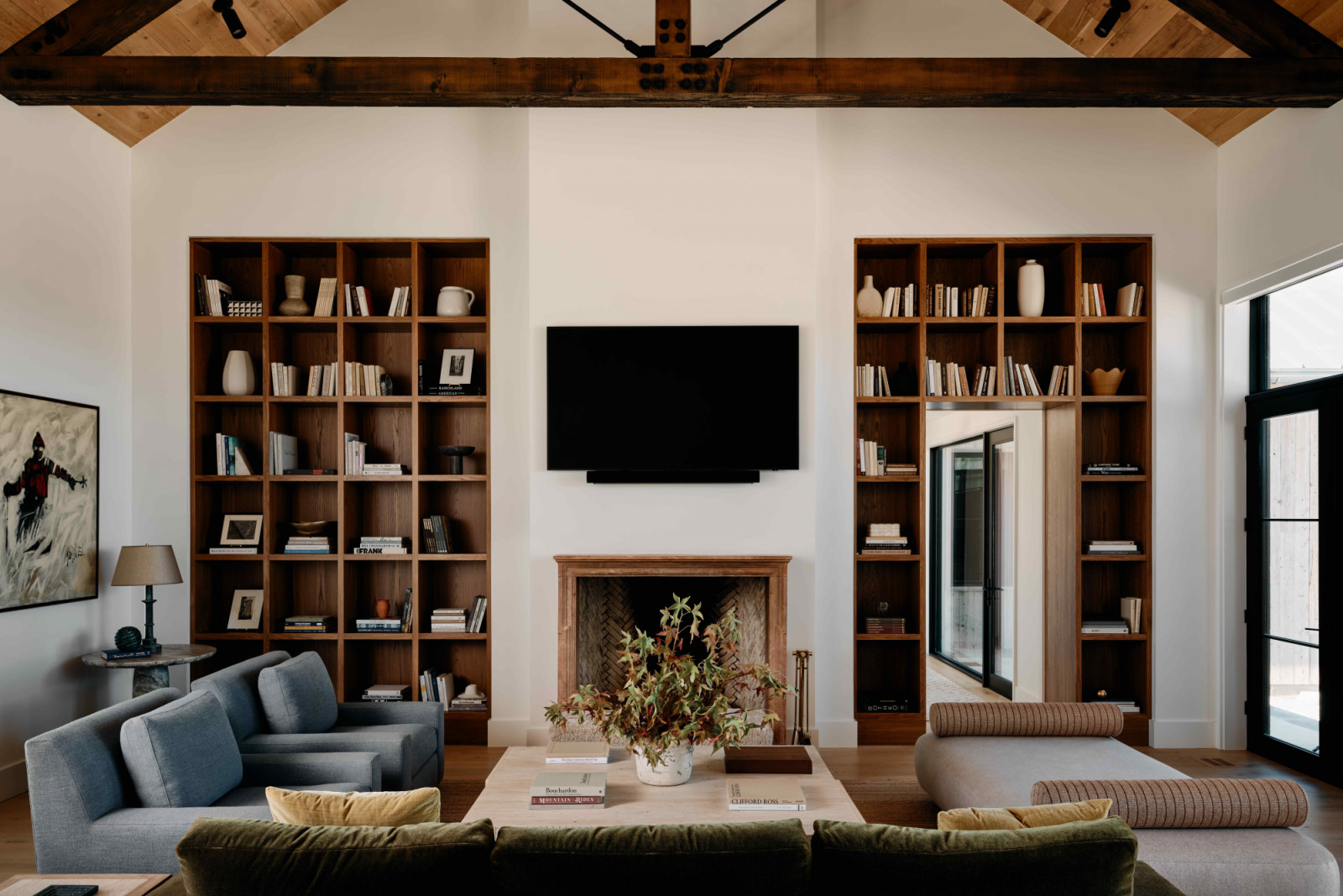 The high-ceilinged living room is part of the dramatic volume known as the great room