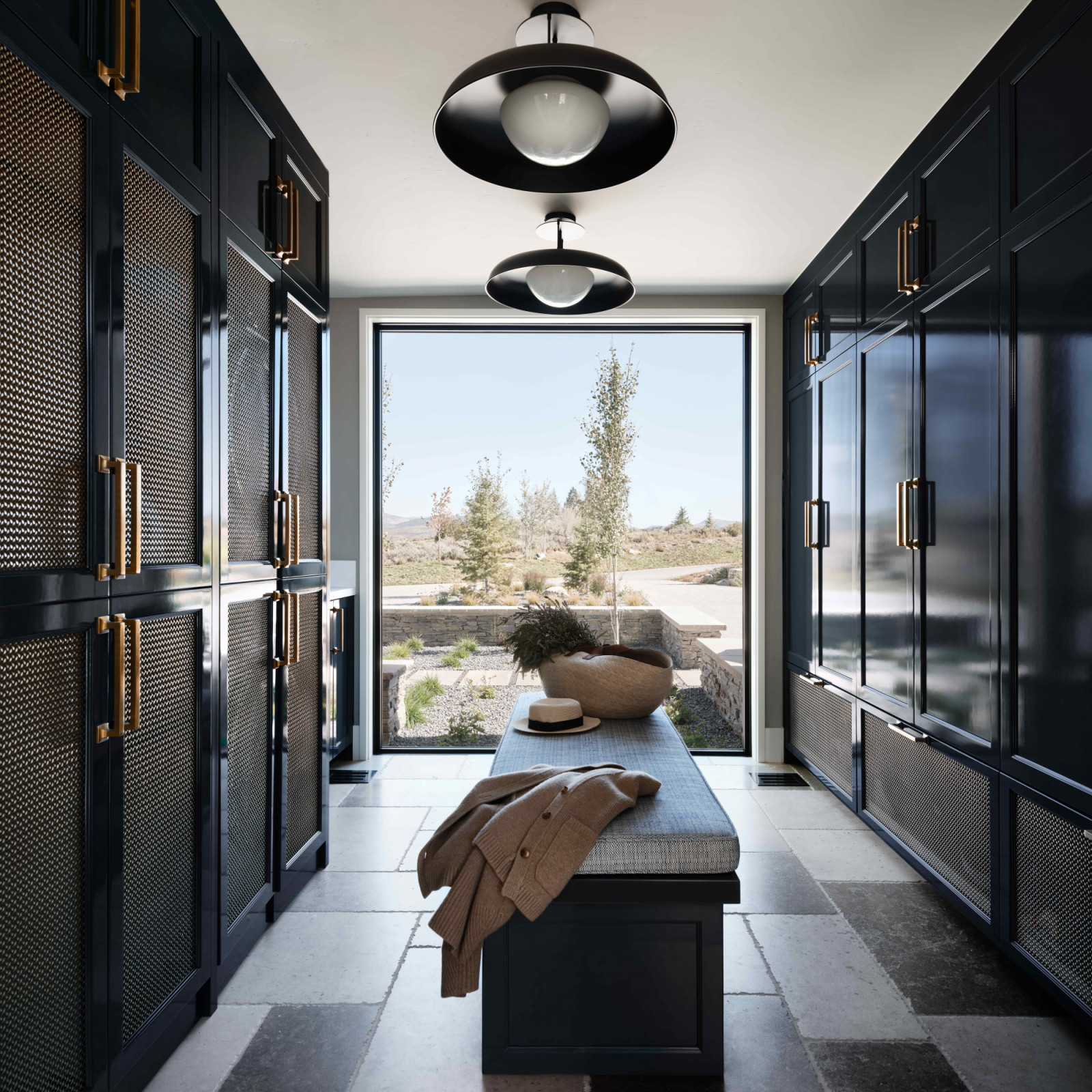 The mudroom frames the distant peaks through floor-to-ceiling glazing