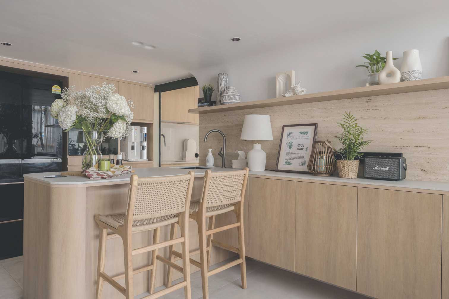 The timber-clad kitchen features a durable stone backsplash in a matching shade