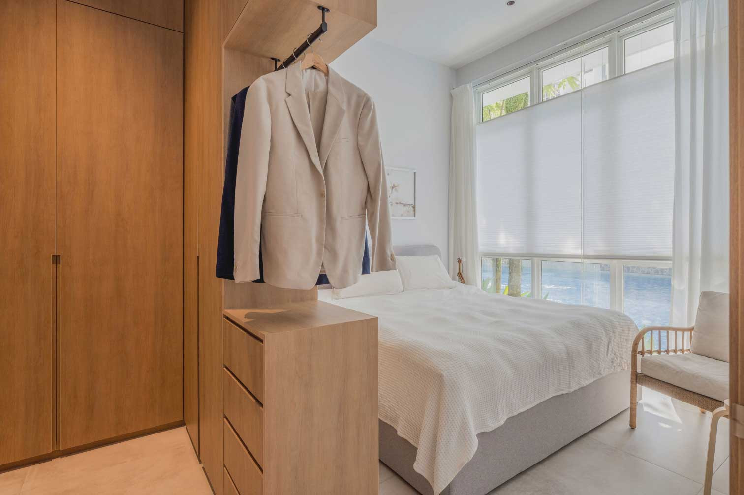 A pure white ceiling and walls meet sandy tones to give the airy master bedroom an easygoing vibe