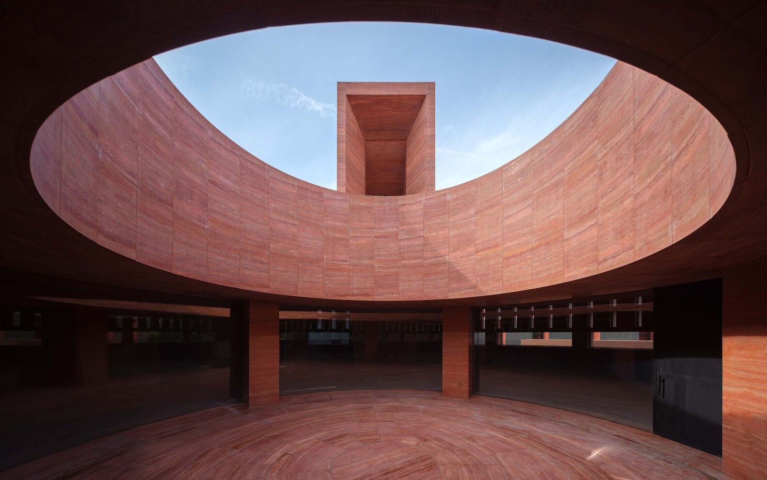 The podium employs a post-and-lintel grid of stone columns, supporting a floating roof (Photo: Instagram / @neriandhu)