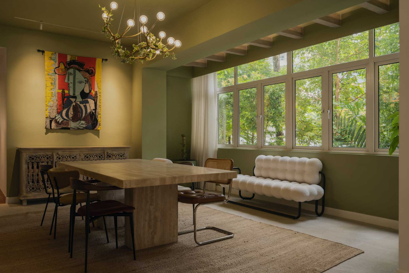 The bohemian living and dining area, where a statement table anchors a set of mismatched dining chairs