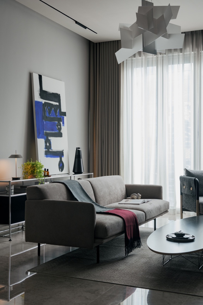 The man cave features a Frog sofa by Living Divani beneath a Big Bang pendant by Foscarini