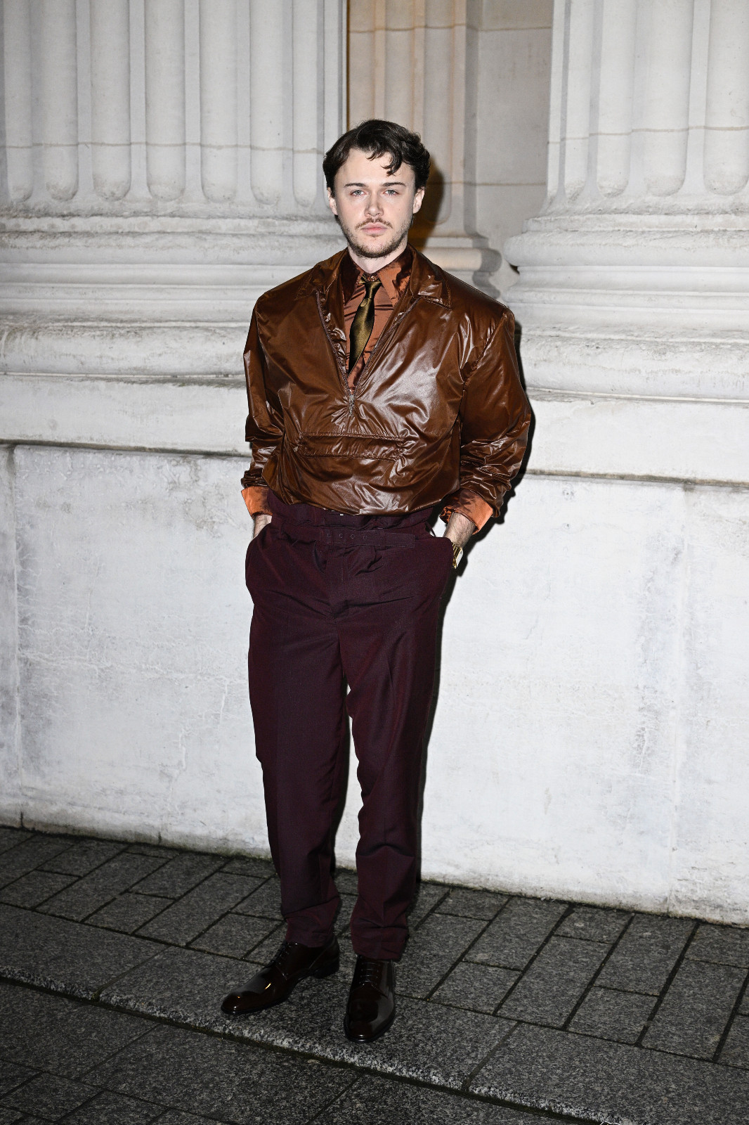 Christopher Briney in chocolate leather at the Saint Laurent show (Photo by Kristy Sparow/Getty Images)