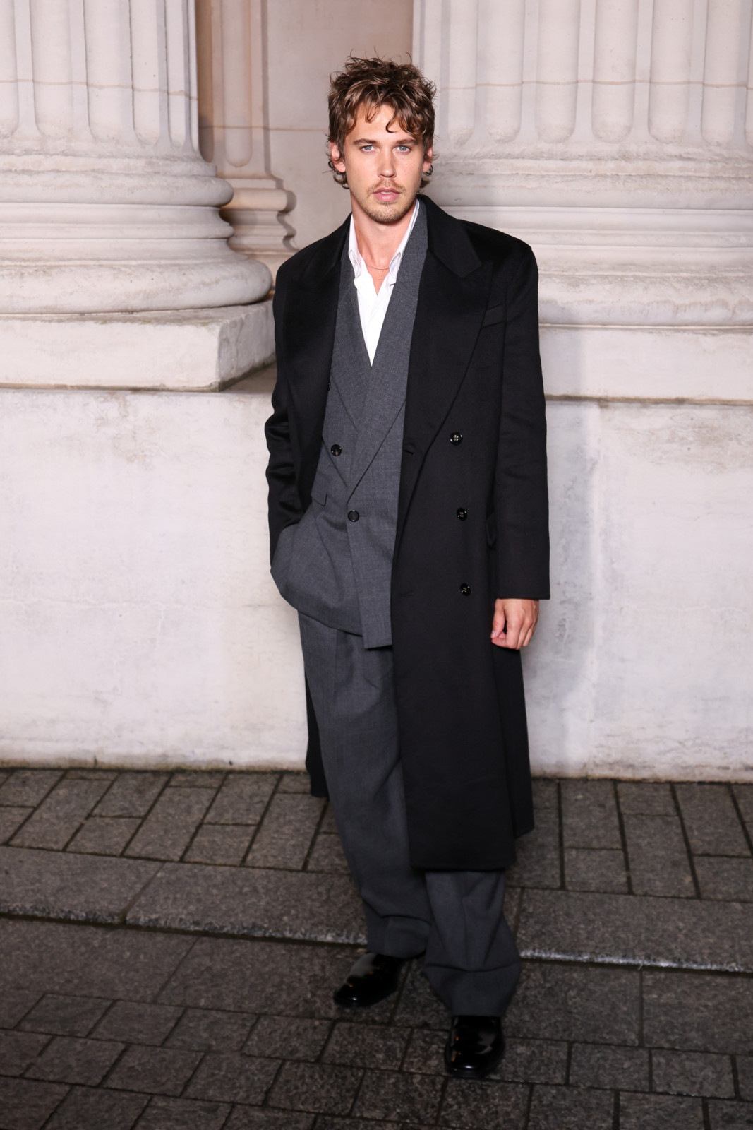 Austin Butler is caught looking rockstar cool at the Saint Laurent show in Paris (Photo by Stephane Cardinale - Corbis/Corbis via Getty Images)