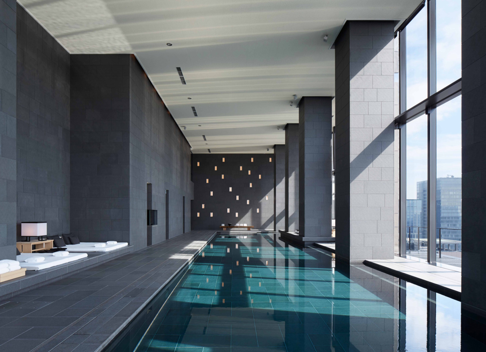 Framed by soaring glazing, the pool offers a composed panorama of Tokyo’s layered cityscape, balancing openness with complete visual privacy