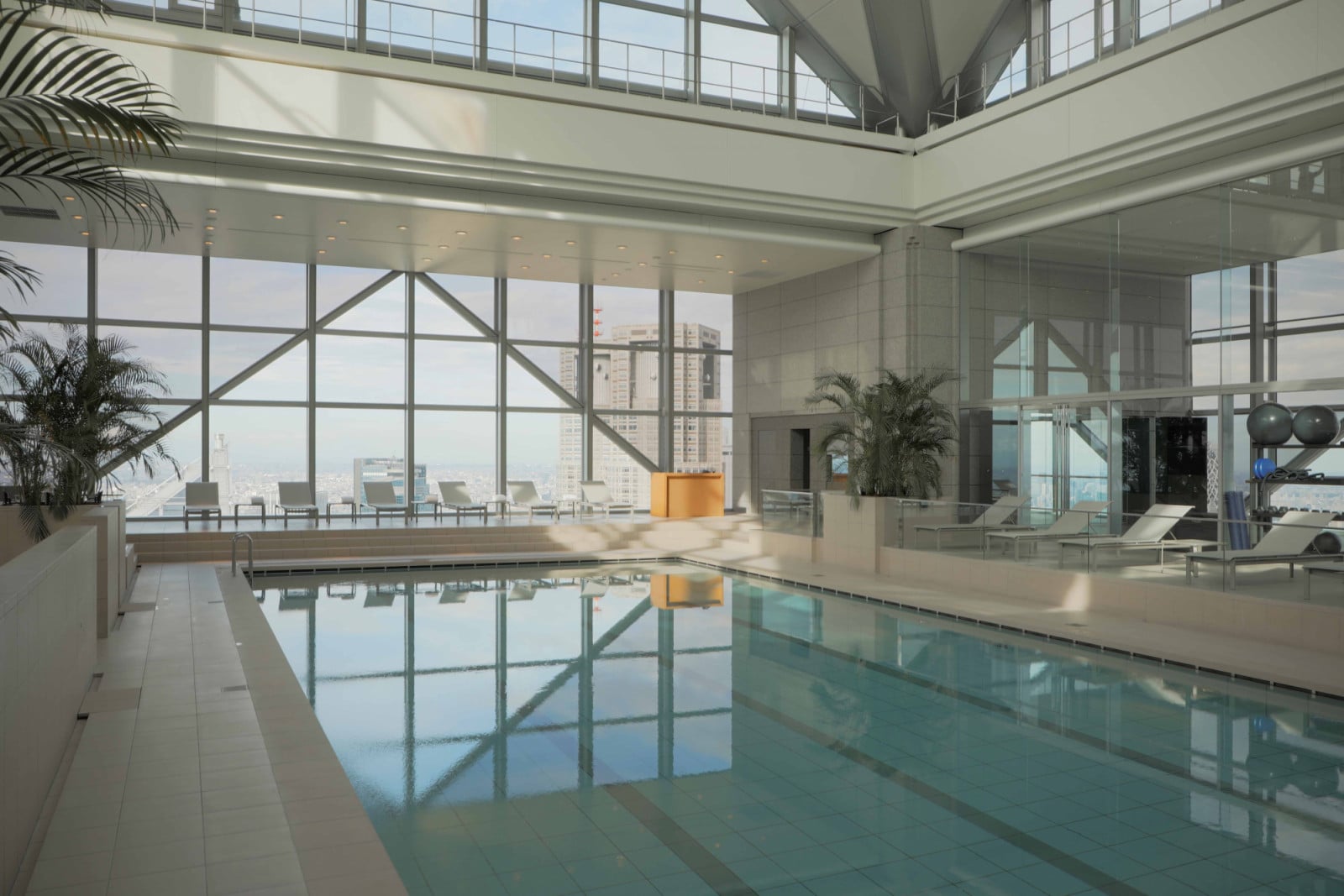 By day, the swimming pool at Park Hyatt Tokyo feels suspended above the city, where daylight and panoramic views accentuate its club-like atmosphere