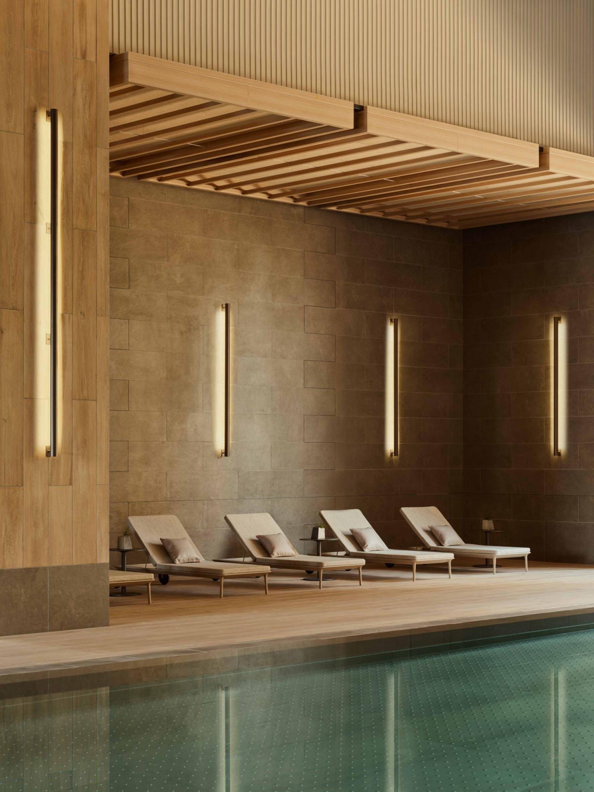 Along the edge of the wellness pool at Janu Tokyo, generously spaced loungers encourage unhurried pauses