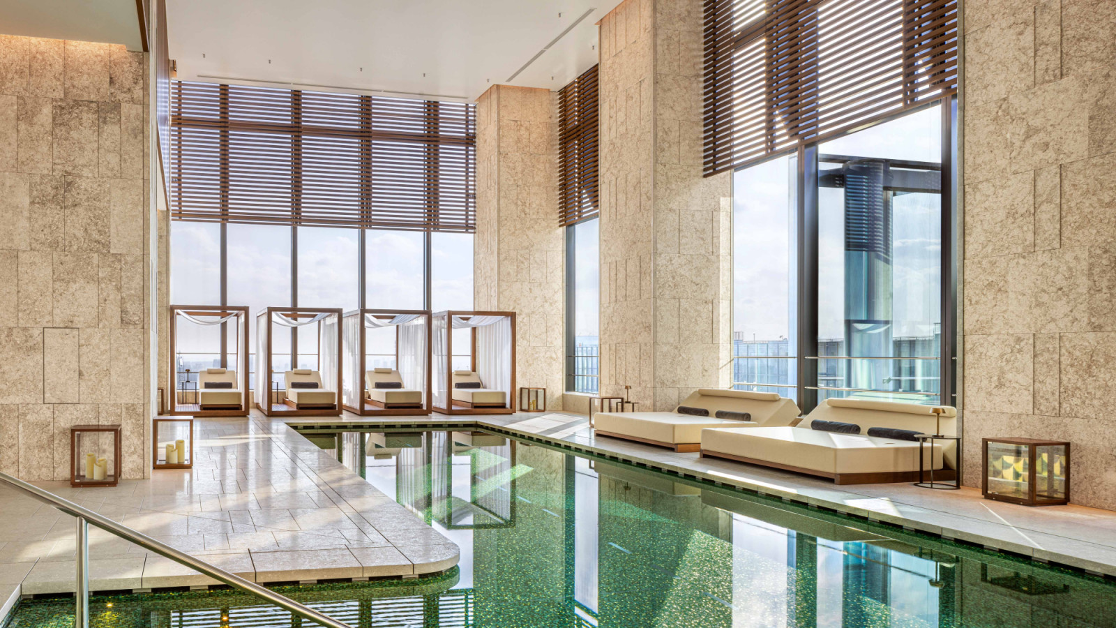 At Bulgari Hotel Tokyo, wooden cabanas lined with drapery frame the pool, affording privacy alongside expansive city views