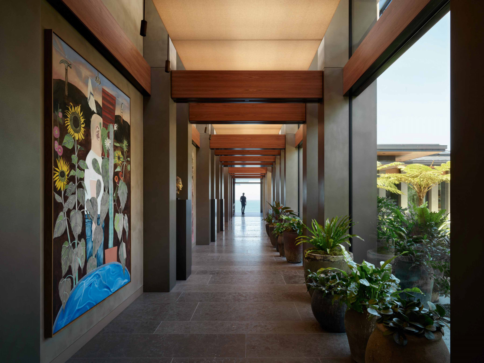 The Infinity House’s roomy corridor lined with artworks leads to the garden