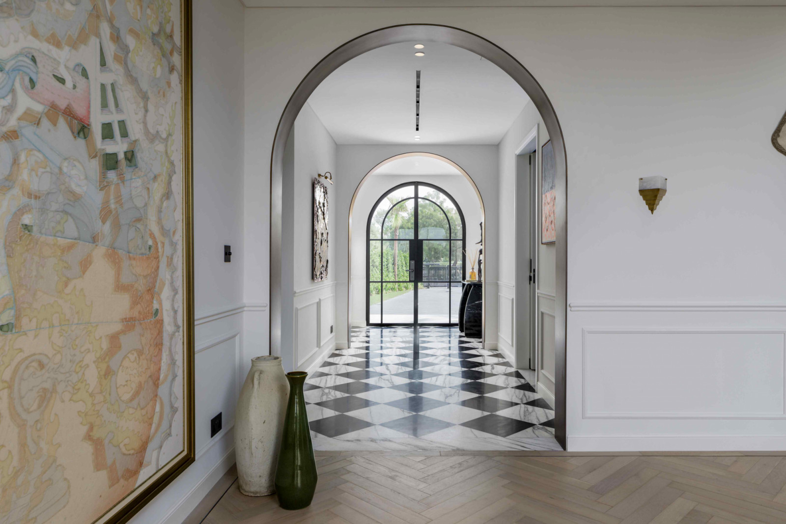 The homeowner’s extensive art collection on display along the entryway