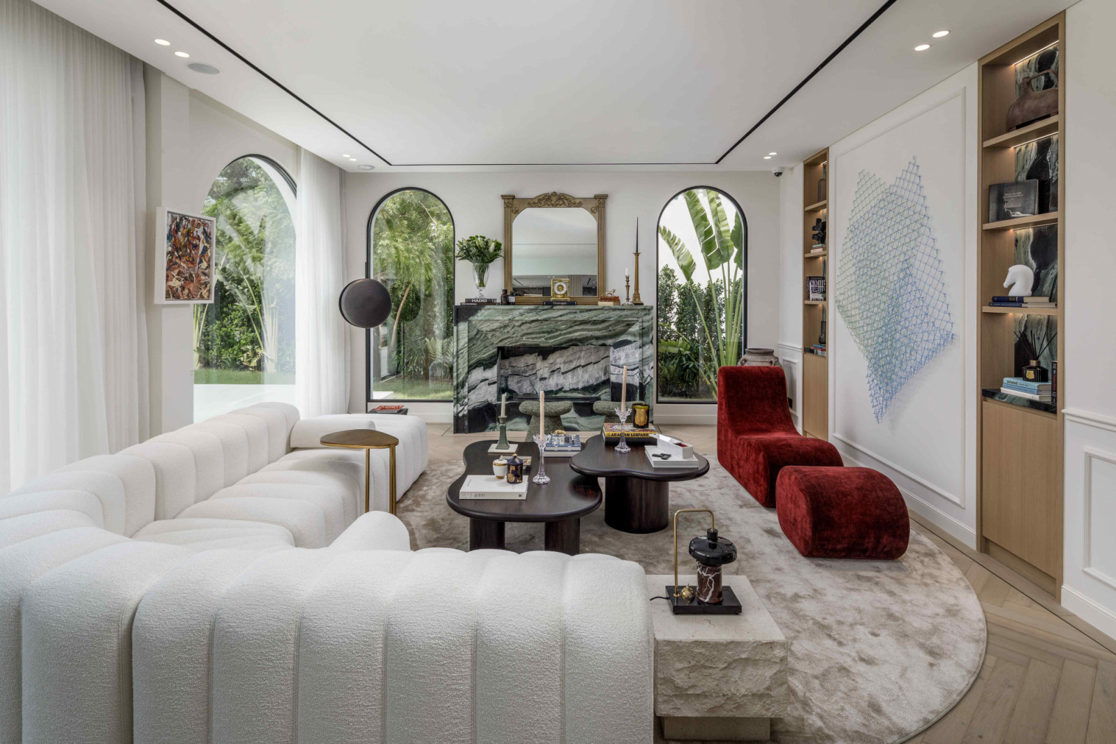 The Cipollino Nuvolato marble fireplace in the living room introduces a verdant note