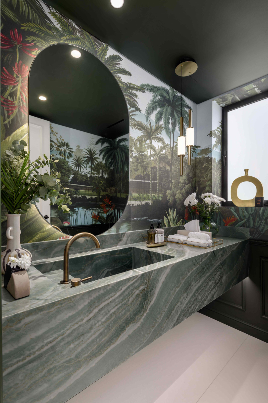 The powder room dressed in tropical-inspired Ananbo wallpaper
