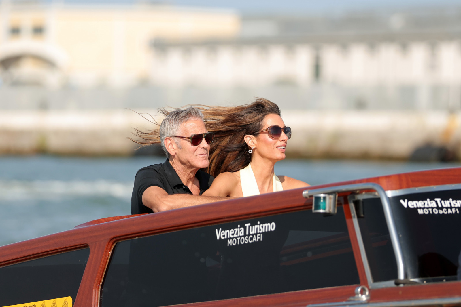 VENICE, ITALY - AUGUST 26: (L-R) George Clooney and Amal Clooney are seen arriving into Venice ahead of the 82nd Venice International Film Festival 2025 on August 26, 2025 in Venice, Italy. (Photo by Jacopo Raule/GC Images)