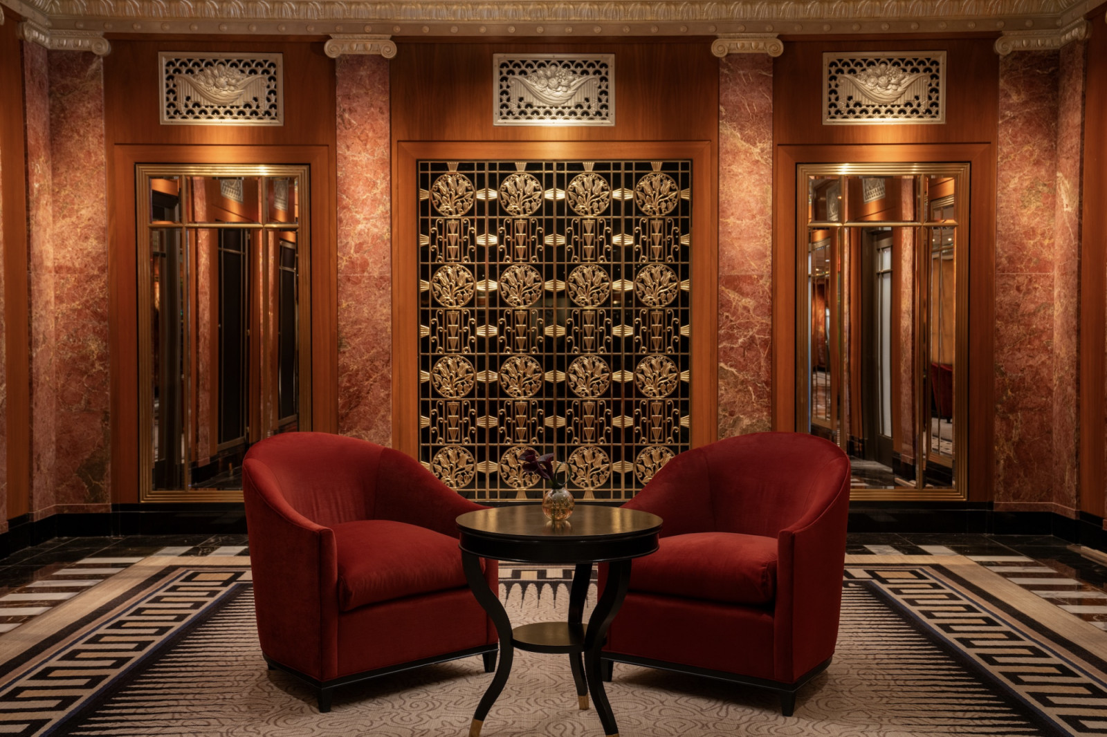 Art Deco elevator lobbies retain original bronze metalwork and geometric patterns, preserving the film hotel’s 1931 architectural heritage