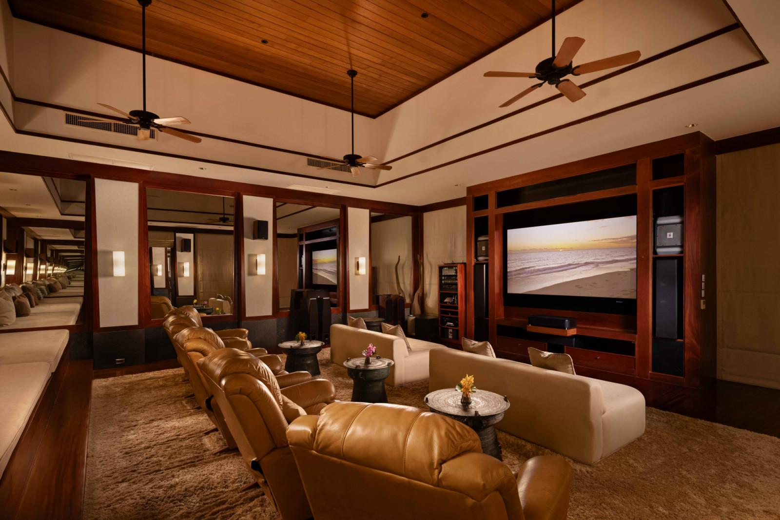 Chandara’s media room is furnished with plush leather chairs in a home-theatre setting