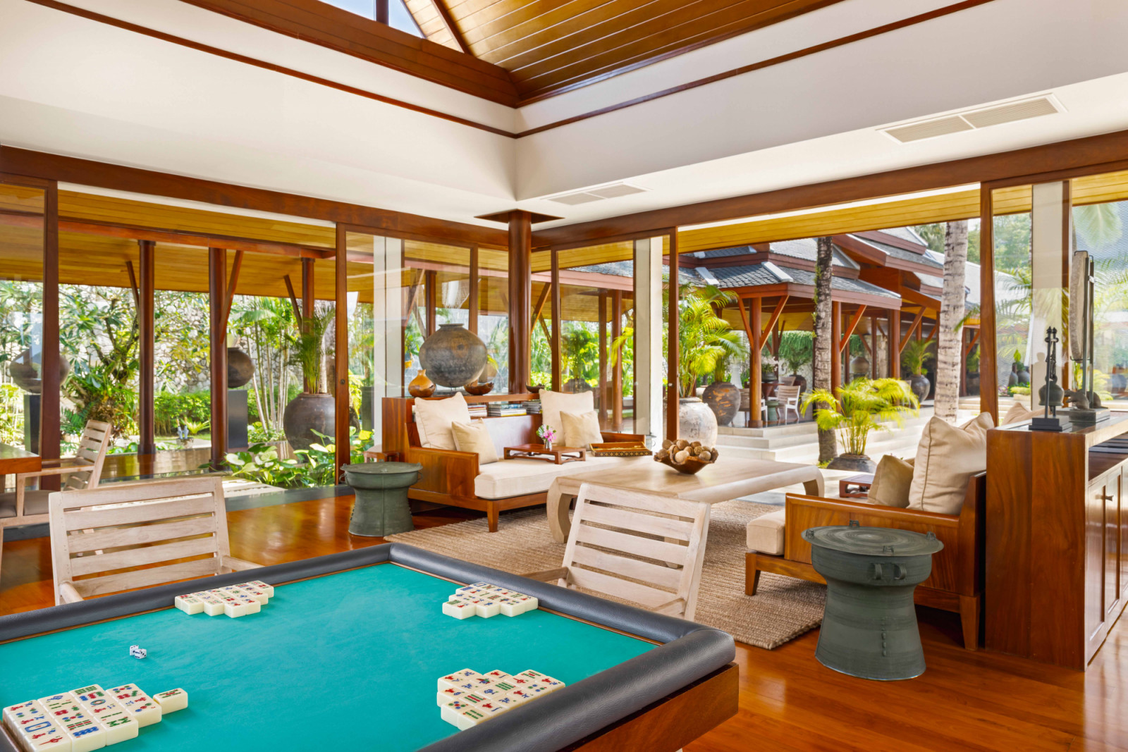 The Library is conceived as a relaxed communal sala, equipped with various games including a mahjong table and board games, encouraging long, unhurried gatherings throughout the day