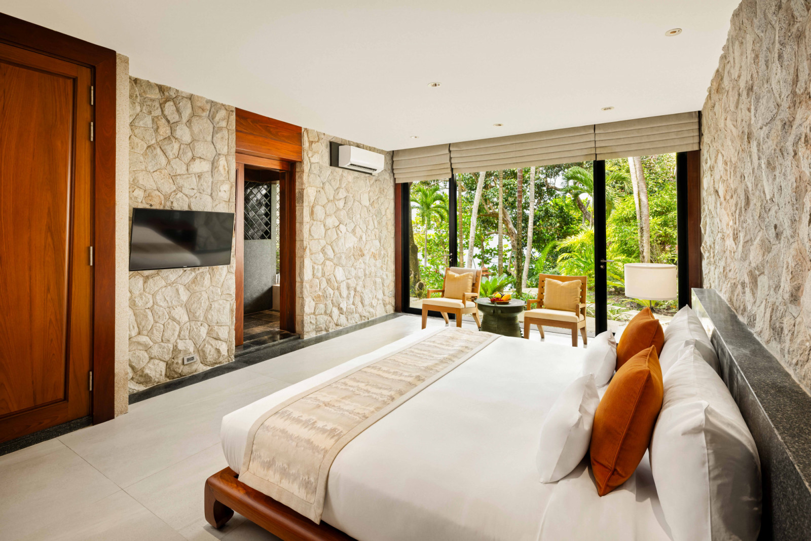 The Ocean Family Bedroom is finished in white stone, creating a calm, tranquil retreat softened by garden views