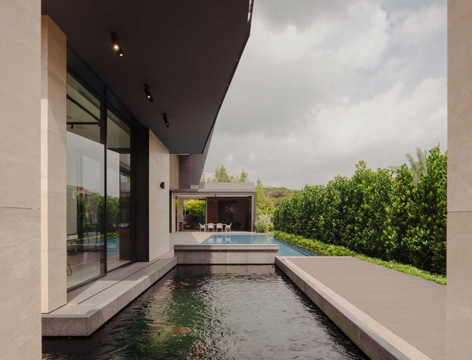 Note how the koi pond, generous swimming pool, and layered roofs and canopies work together to complete a dynamic and seamless transition between areas