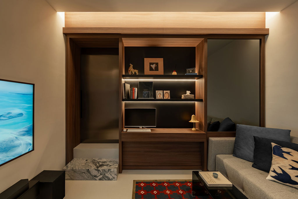 The first-floor study area features built-in walnut shelving with integrated lighting and a custom desk unit