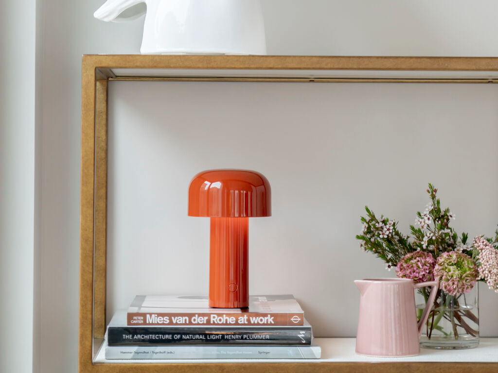 The distinctive mushroom-like profile casts a gentle, even pool of warm light (Photo: Flos)