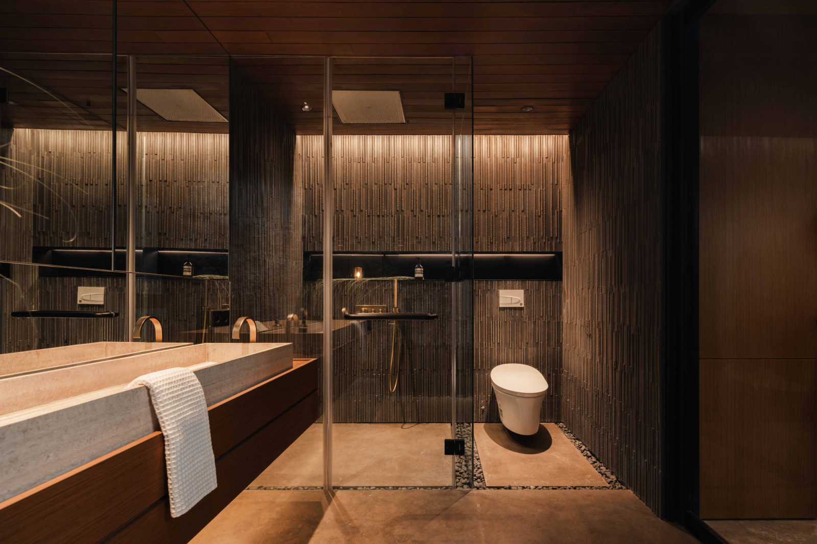 The toilet and shower are separated at the far end of the bathroom for privacy and clarity of use