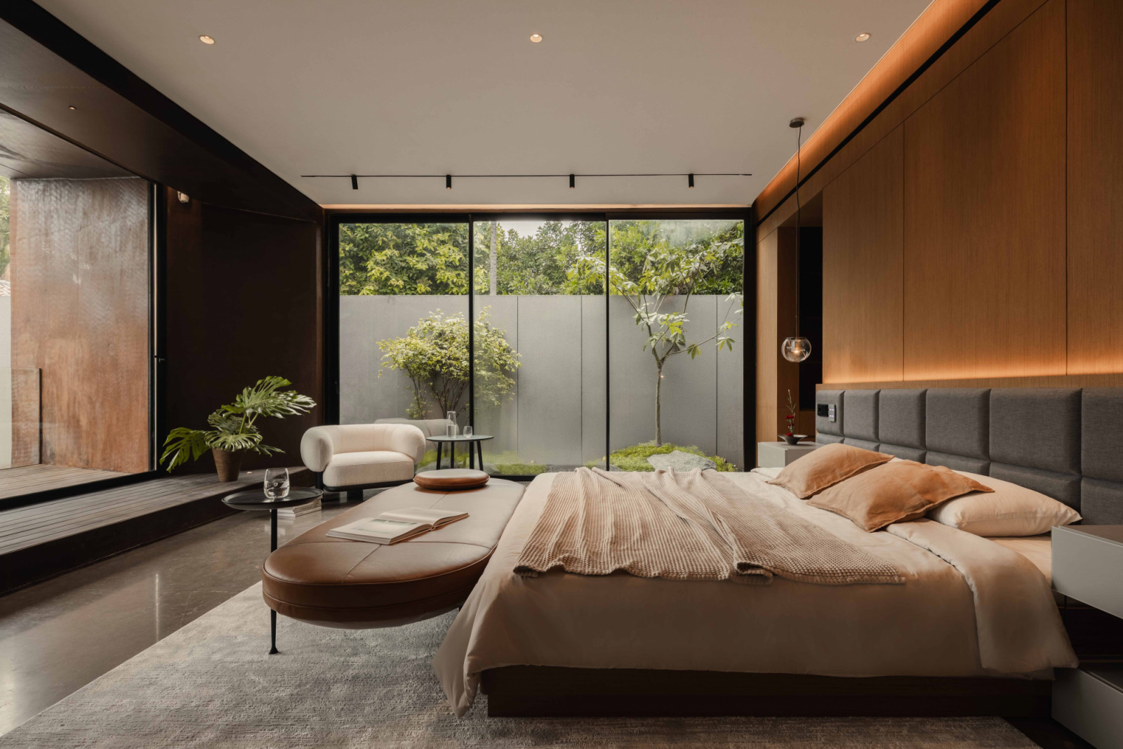 This stylish ground-floor bedroom maintains privacy while opening directly to a planted courtyard