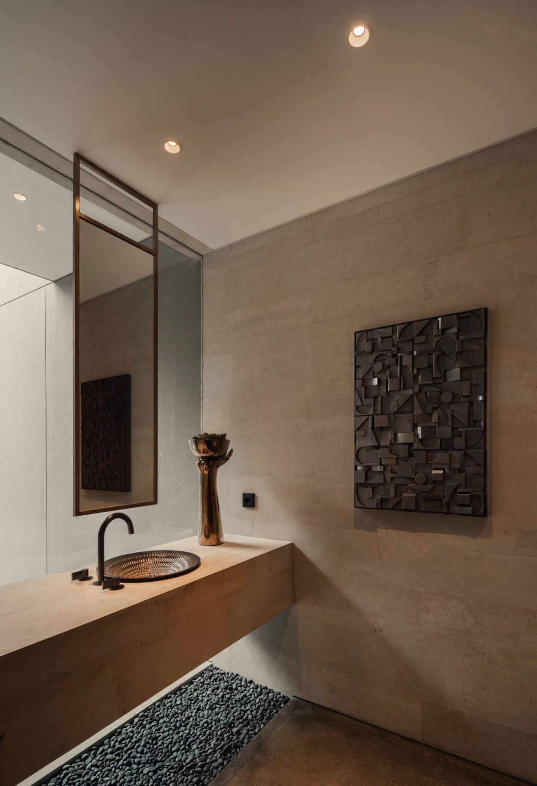 A floating vanity anchors the powder room, reinforcing the home’s clean-cut aesthetic