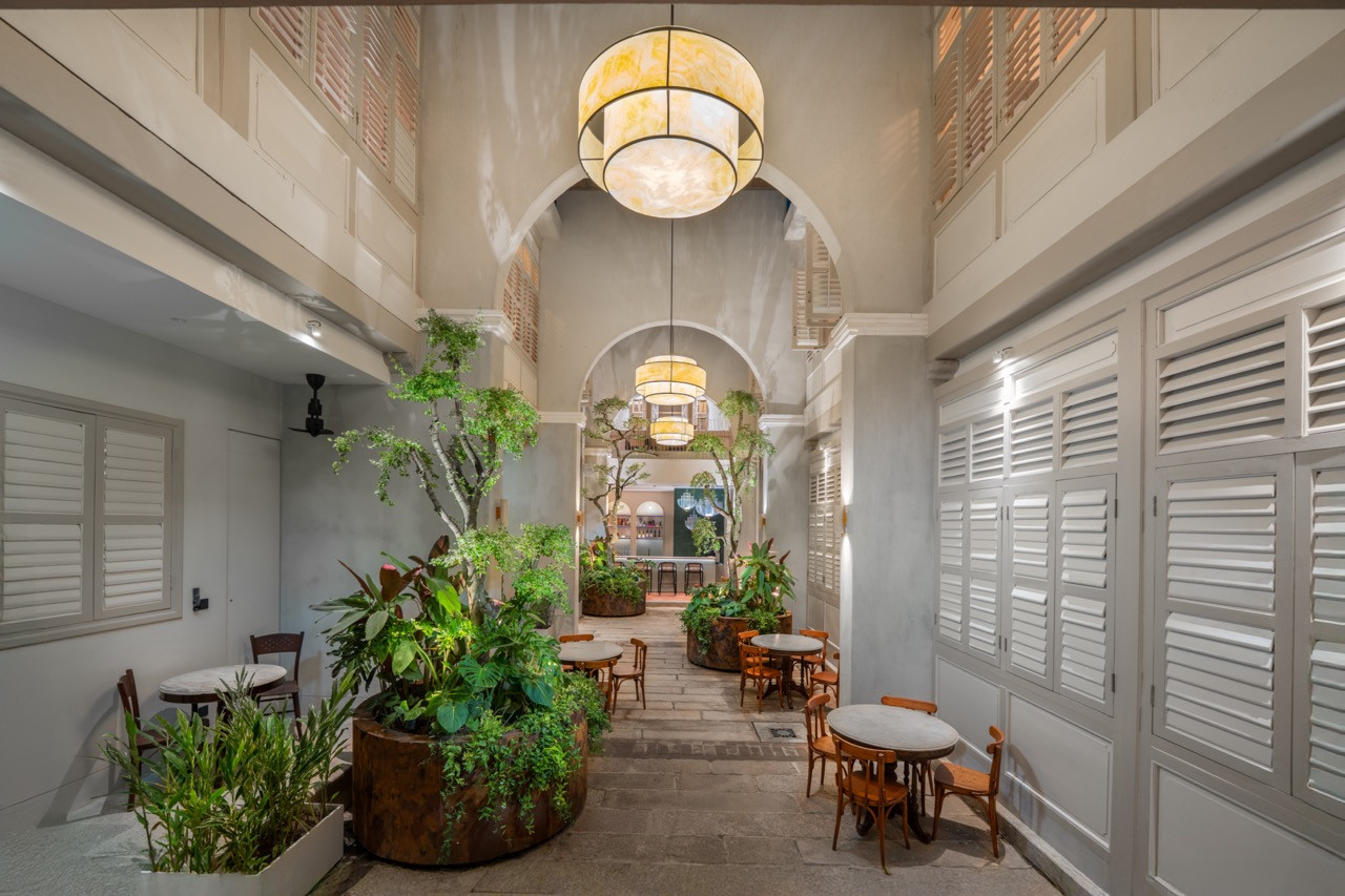 The ground floor corridor along the courtyard, showing how the arches create sightlines through the connected terraces