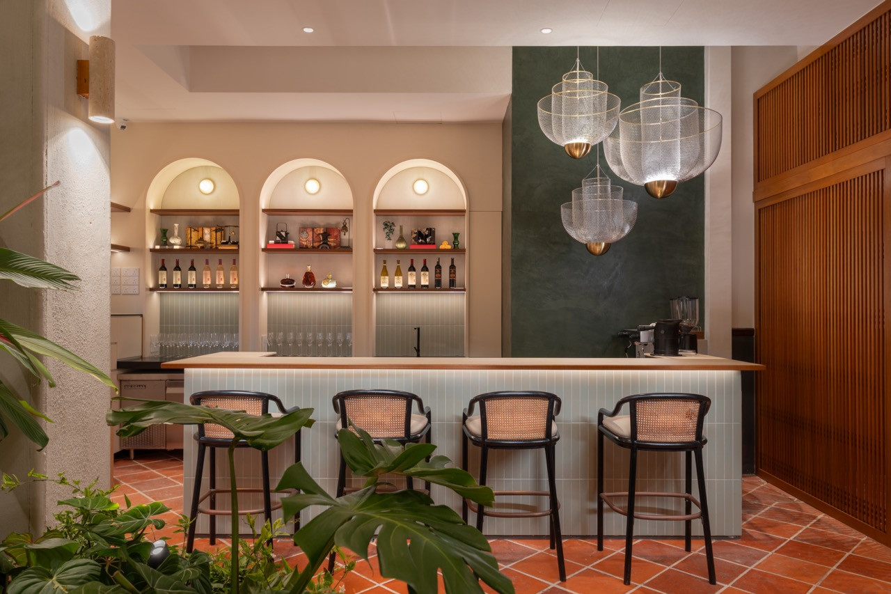The Qing Bar features three arched alcoves backed by sage green walls