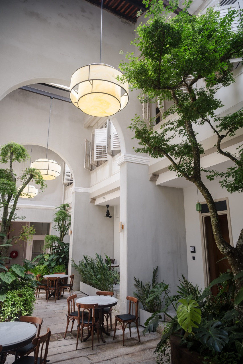 The central courtyard functions as what Loh-Lim calls “the lung of the hotel,” connecting five once-separate terrace houses with natural light and ventilation