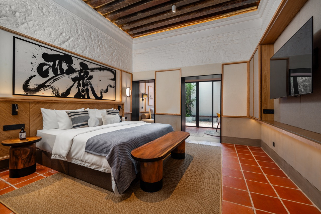 The Garden Suite features exposed ceiling beams, salvaged terracotta flooring and custom timber furniture