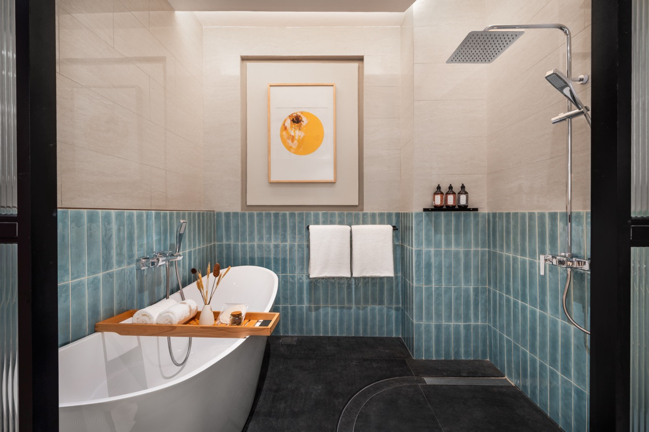 Garden Suite bathroom with ceramic-tile wainscoting and a freestanding tub